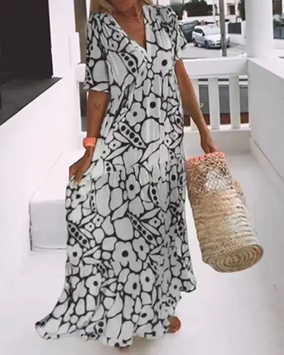 AD | 2024 AliExpress Europeiska och amerikanska kvinnor Gränsöverskridande sommar Nytt mode tryckt kortärmad djup V-hals lång klänning